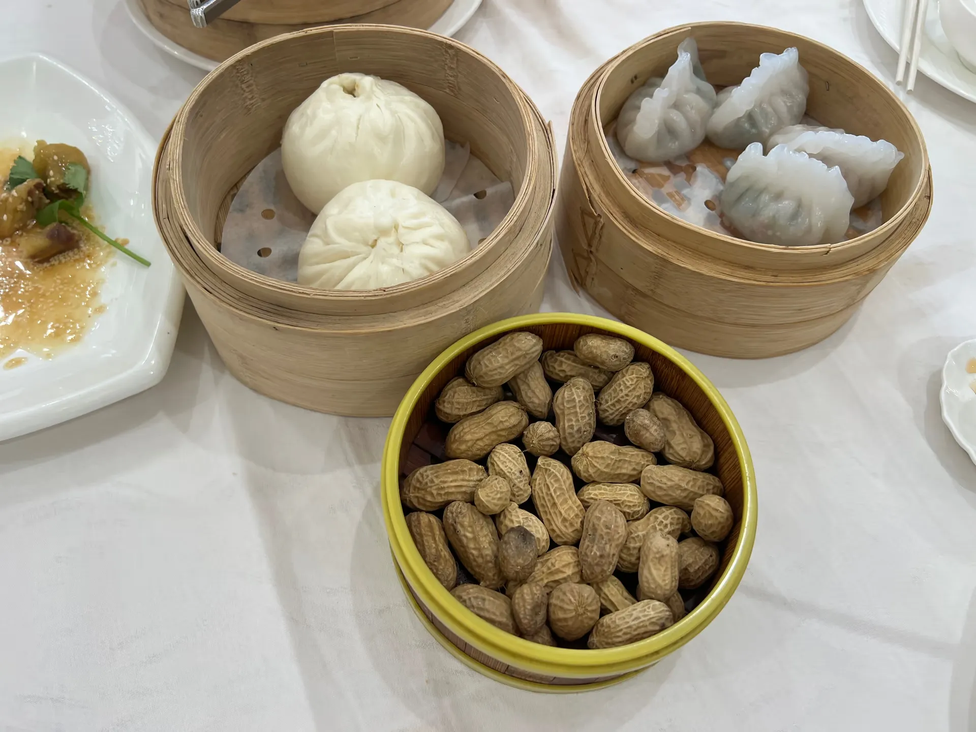 Assorted dim sum, including steamed buns and dumplings with translucent wrappers