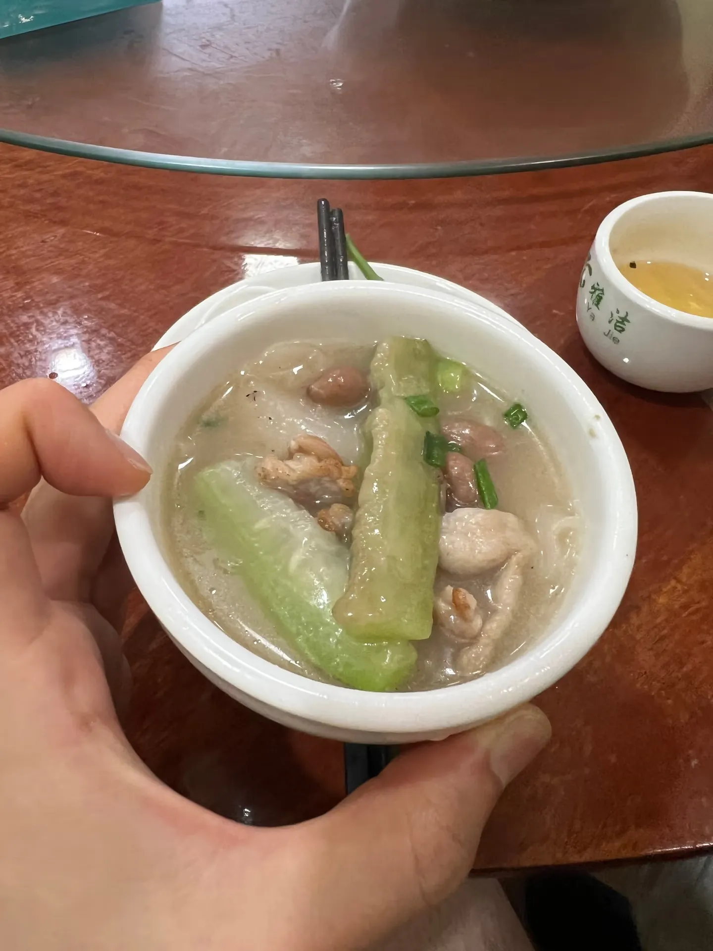 A small bowl of broth with pork and bitter melon