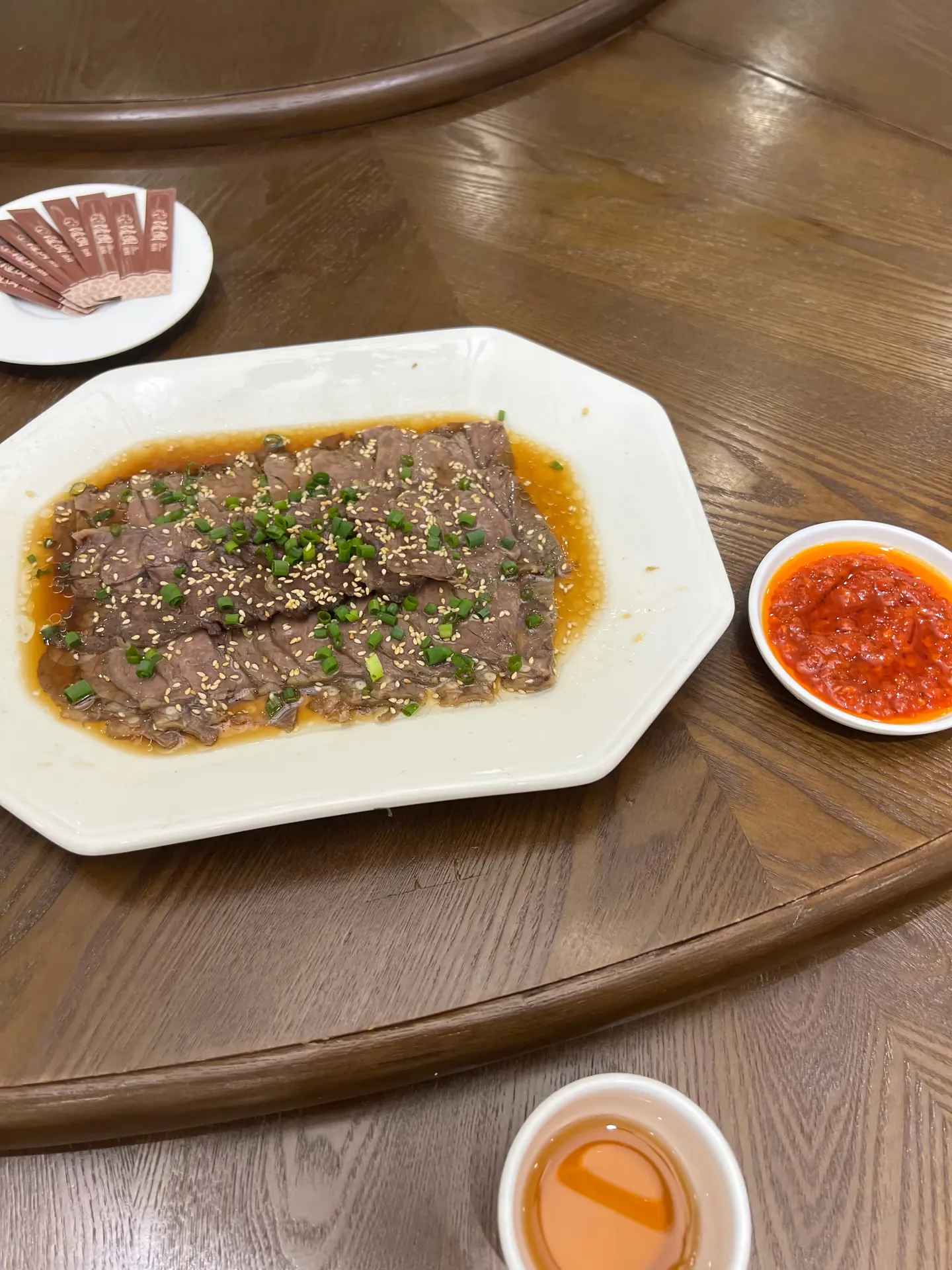 Black sesame tofu on a plate with sauce