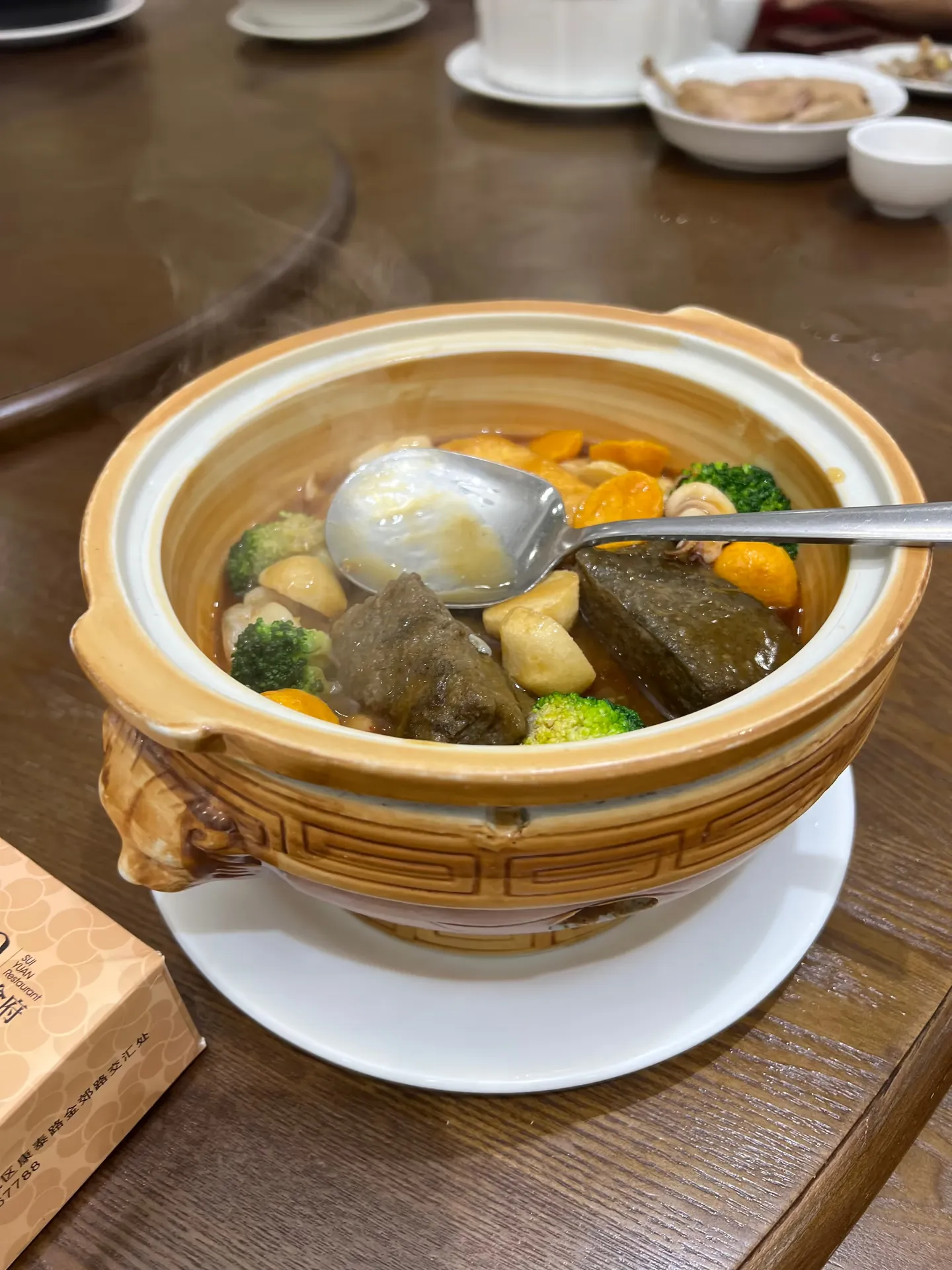 Black sesame tofu with vegetables in a clay pot