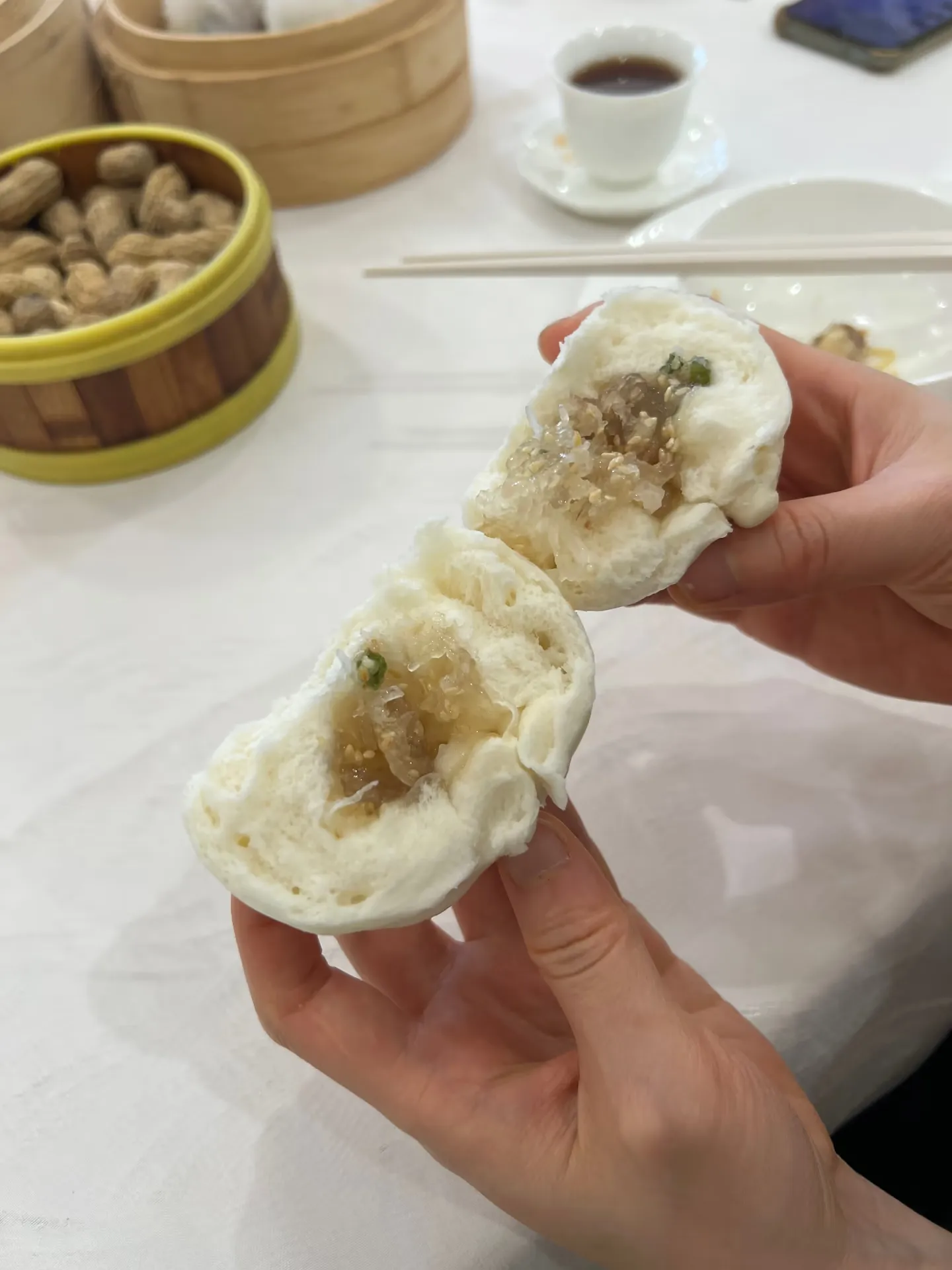 A steamed bun split open to show the filling