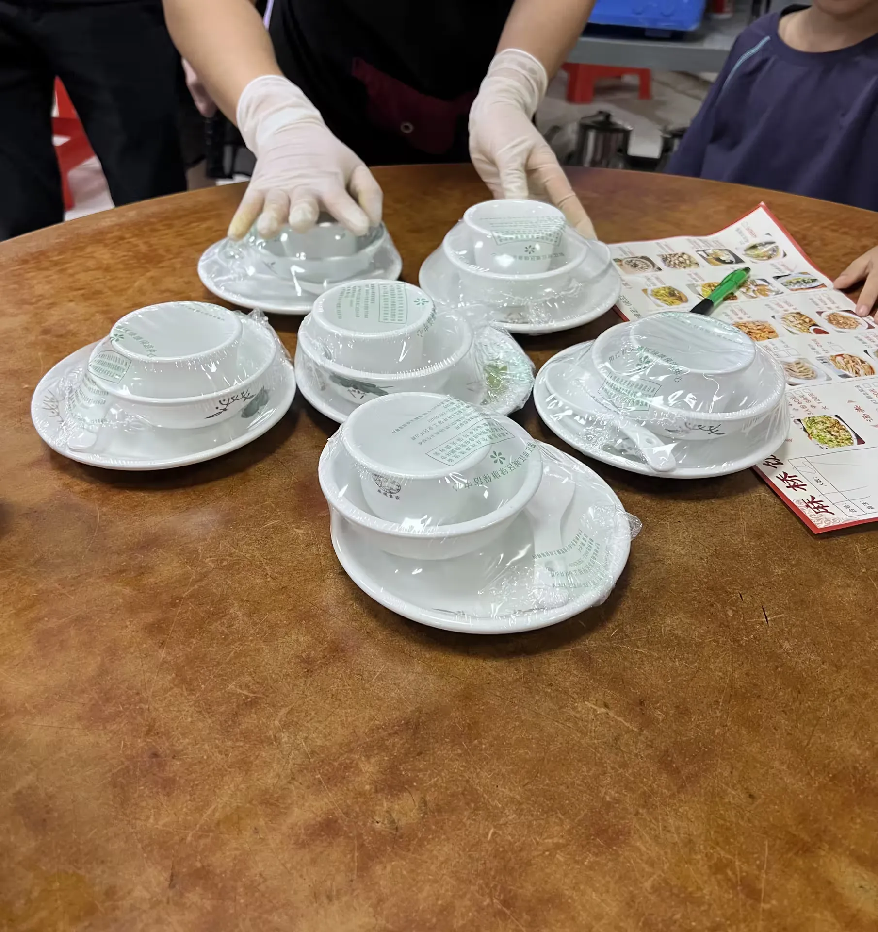 Teacups and dishes stacked on an empty table