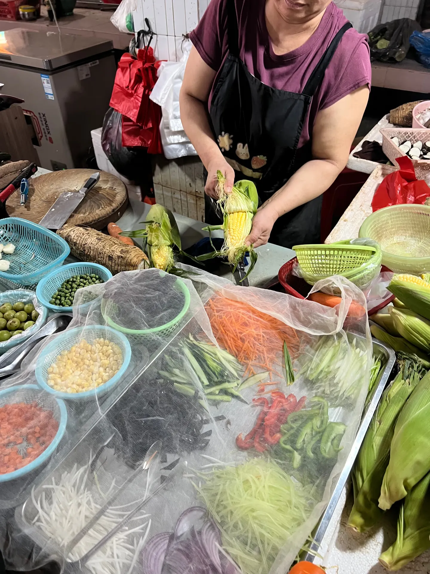 A vendor preparing vegetables
