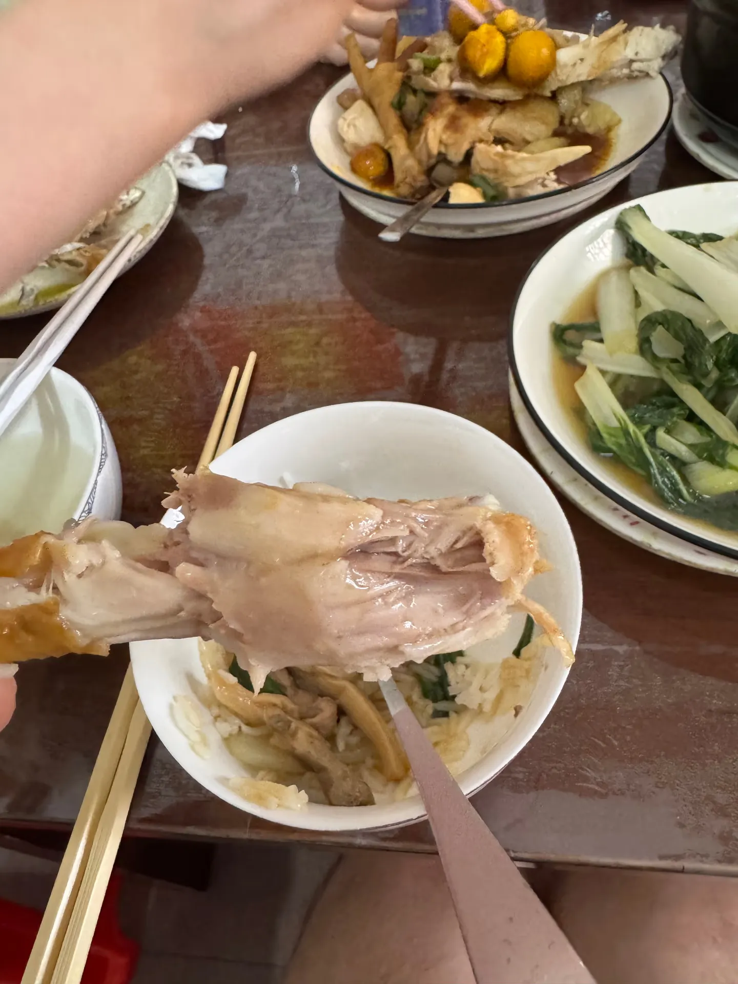 A piece of meat held up with chopsticks