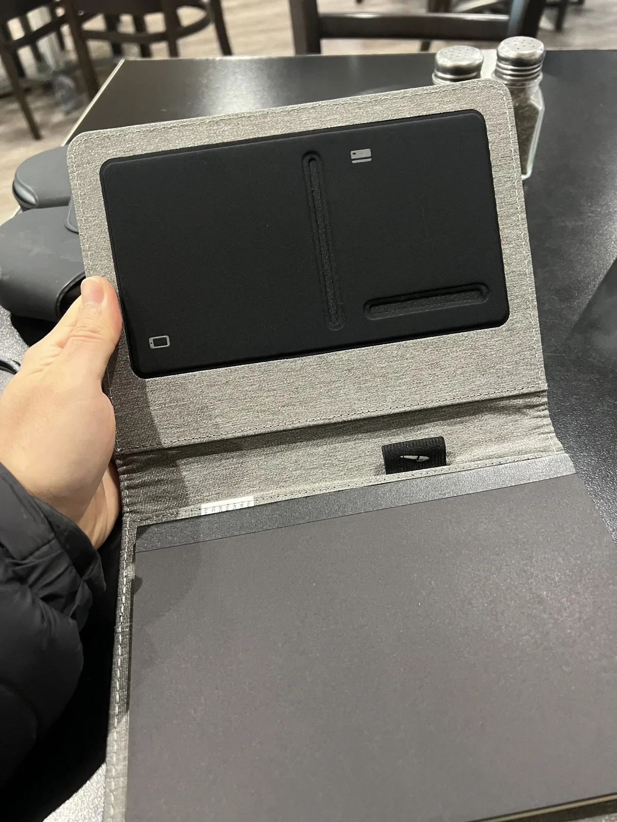 The wireless charging pad on the back of the diary