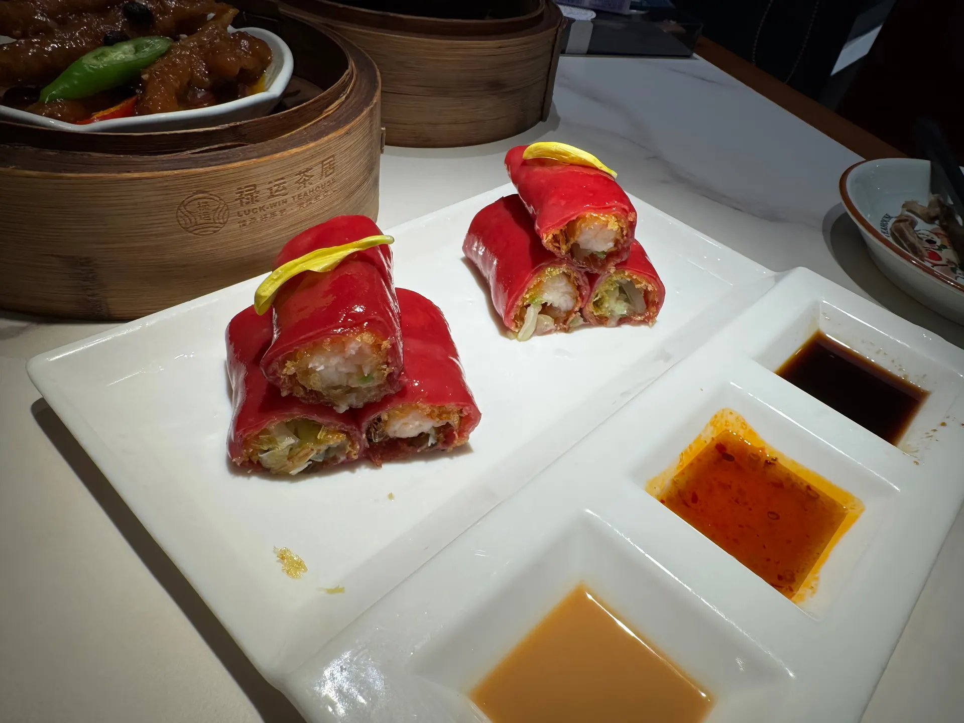 Dim sum wrapped in red rice sheets