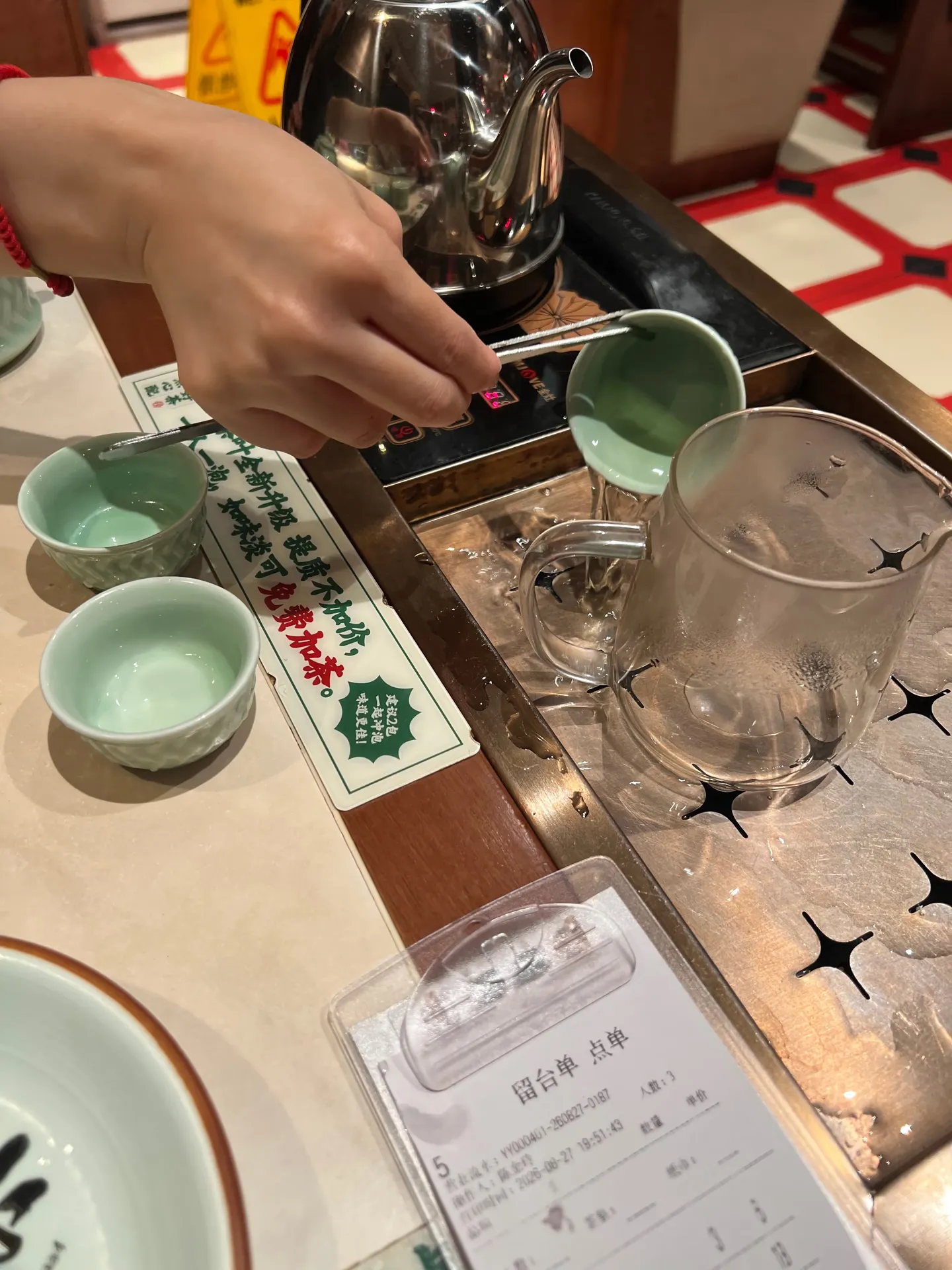 Starting yum cha by rinsing the tableware with hot tea