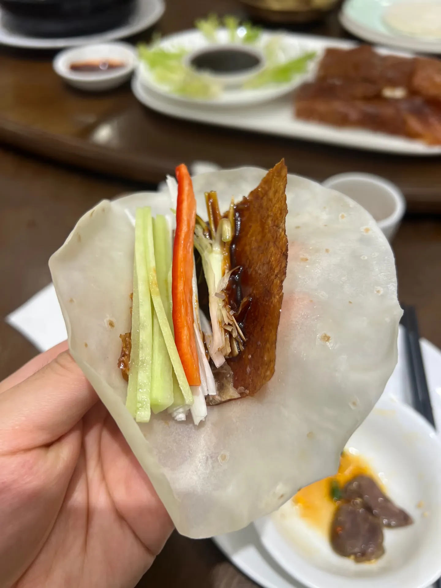 Duck and vegetables wrapped in a thin pancake