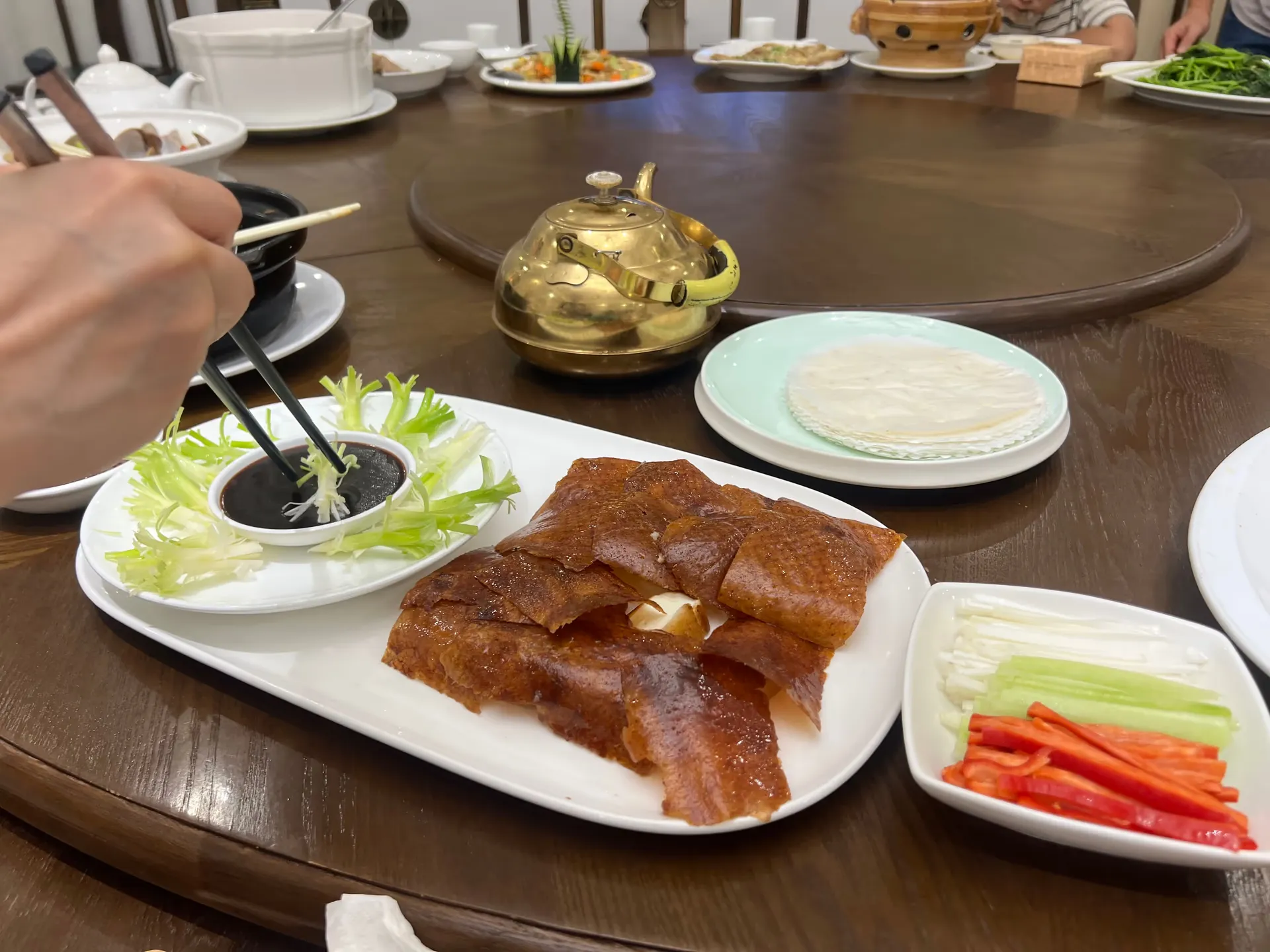 Duck with thin, crisp skin and ingredients for wrapping