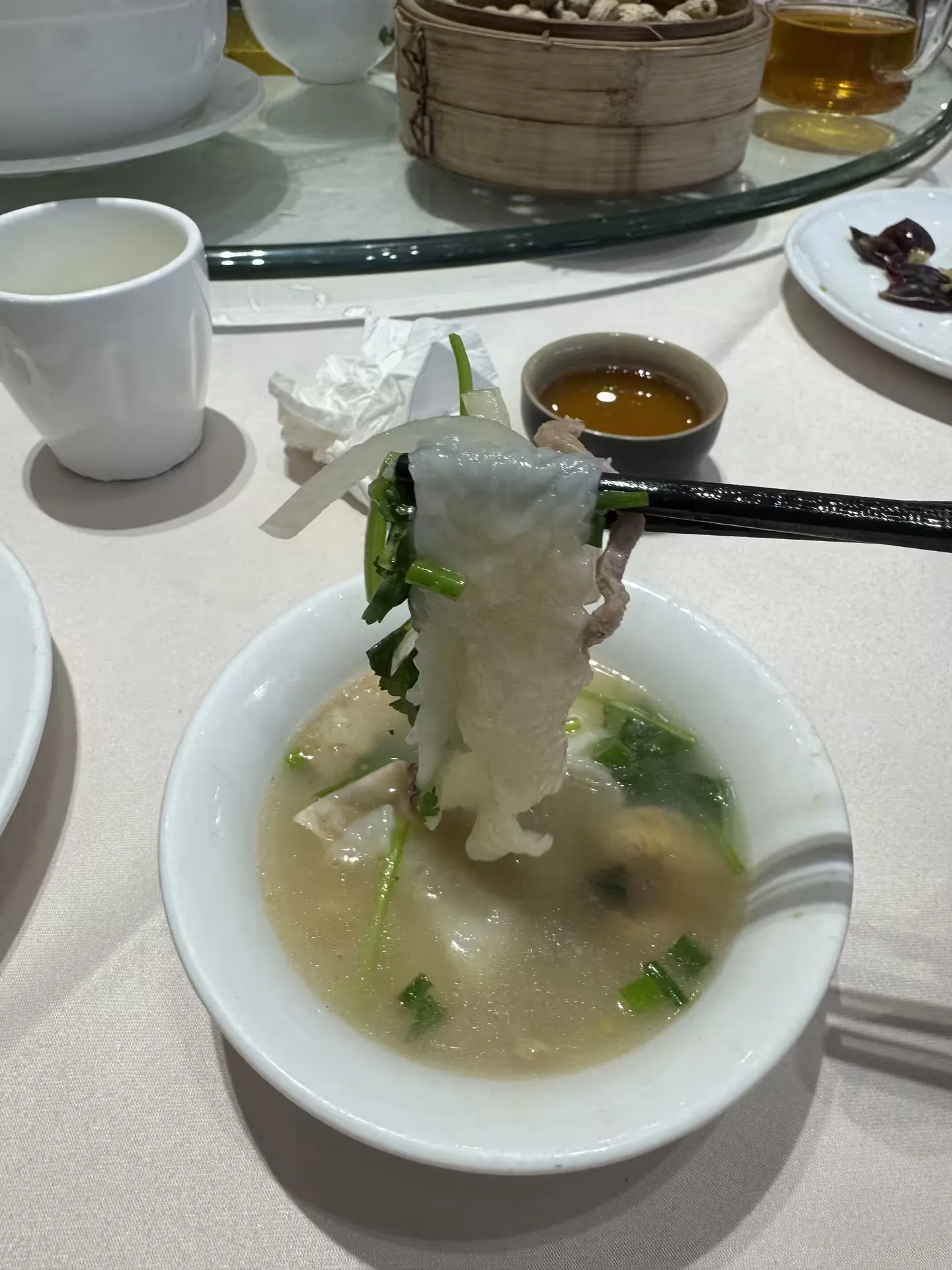 A thin, soft piece of dough lifted from the seafood soup