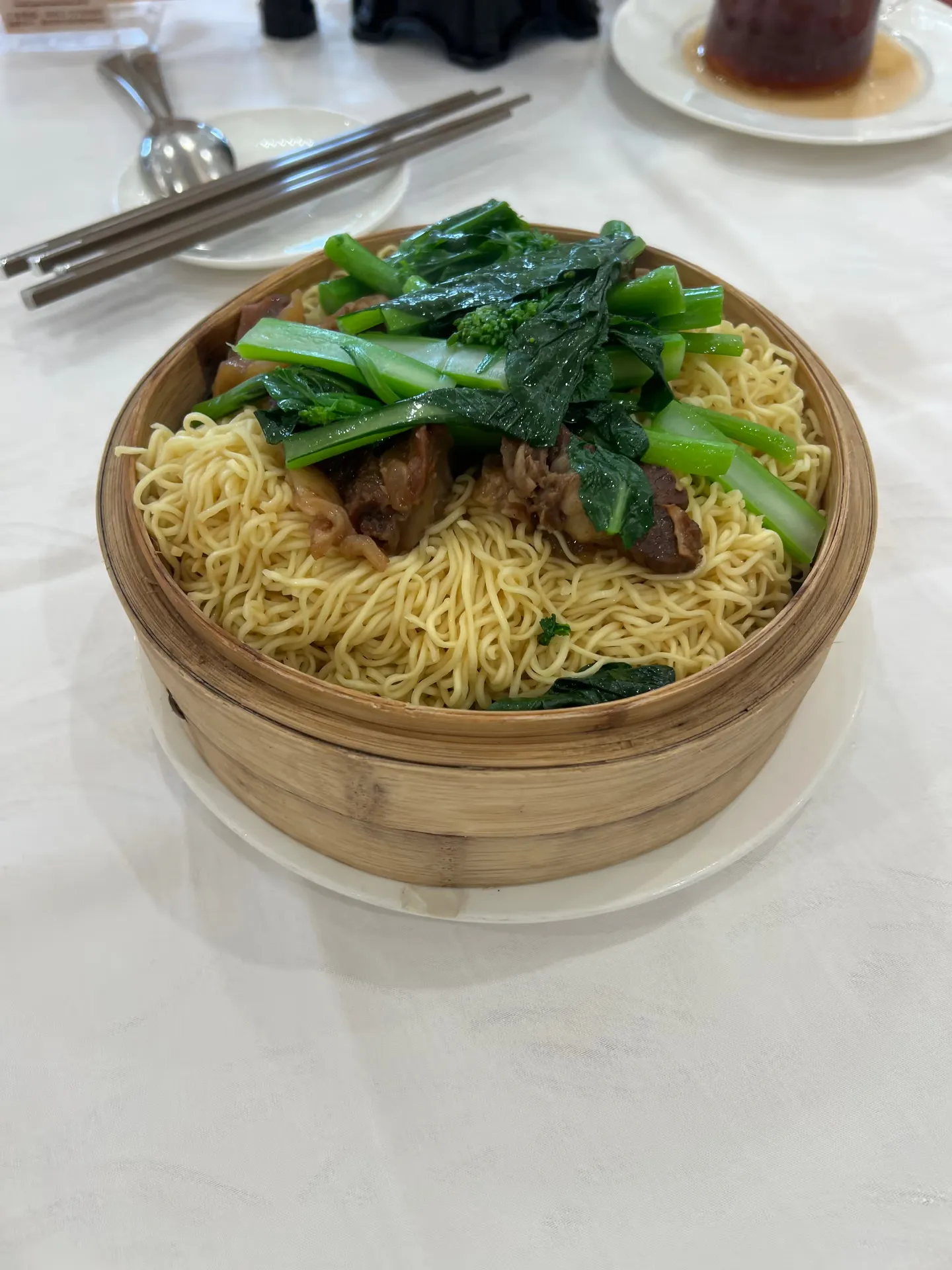 Noodles topped with vegetables and meat
